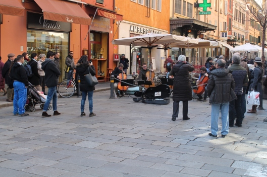 People, actually stopping and listening to classical musicians performing in the street.